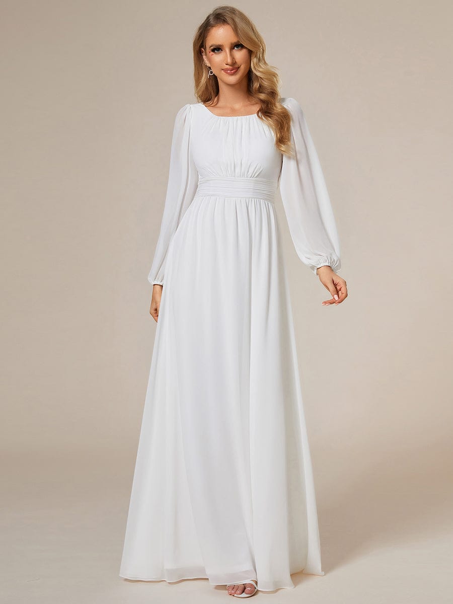 Woman wearing a white Weitese chiffon high empire waist puff sleeve maxi dress.