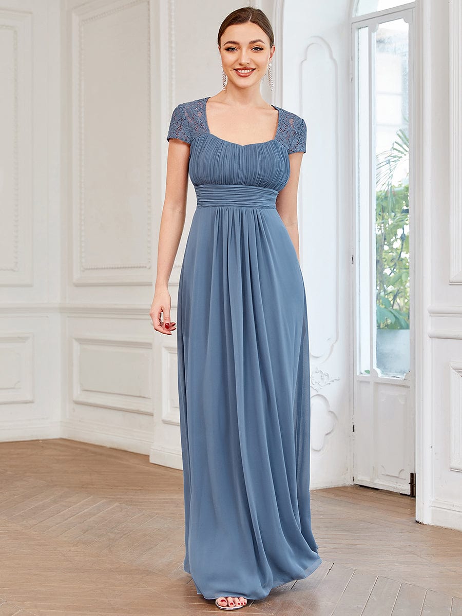 Model wearing a dark chiffon ruched sweetheart A-line bridesmaid dress, front view.