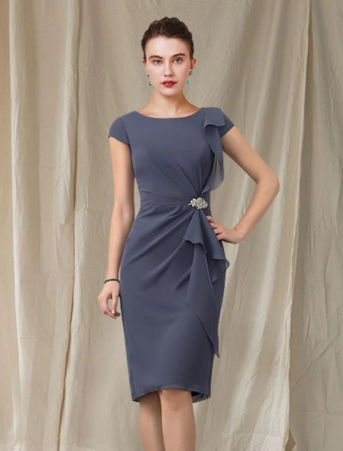 Woman wearing an elegant Weitese chiffon sheath column knee-length dress with cap sleeves and jewel neck.