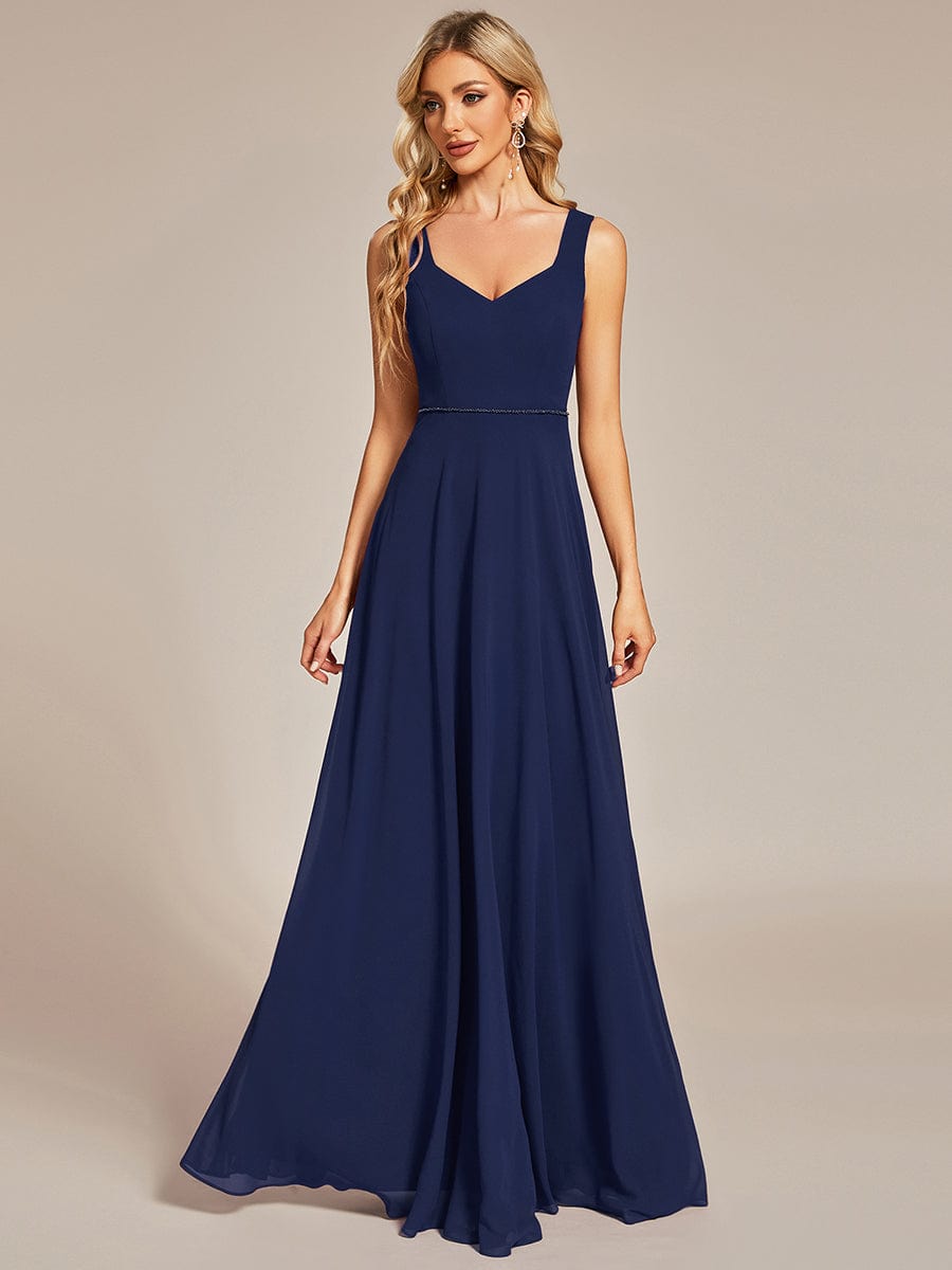 Model in a navy blue chiffon sweetheart sleeveless bridesmaid dress.