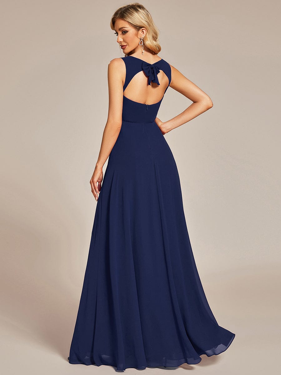 Side view of a navy blue chiffon sweetheart sleeveless dress.
