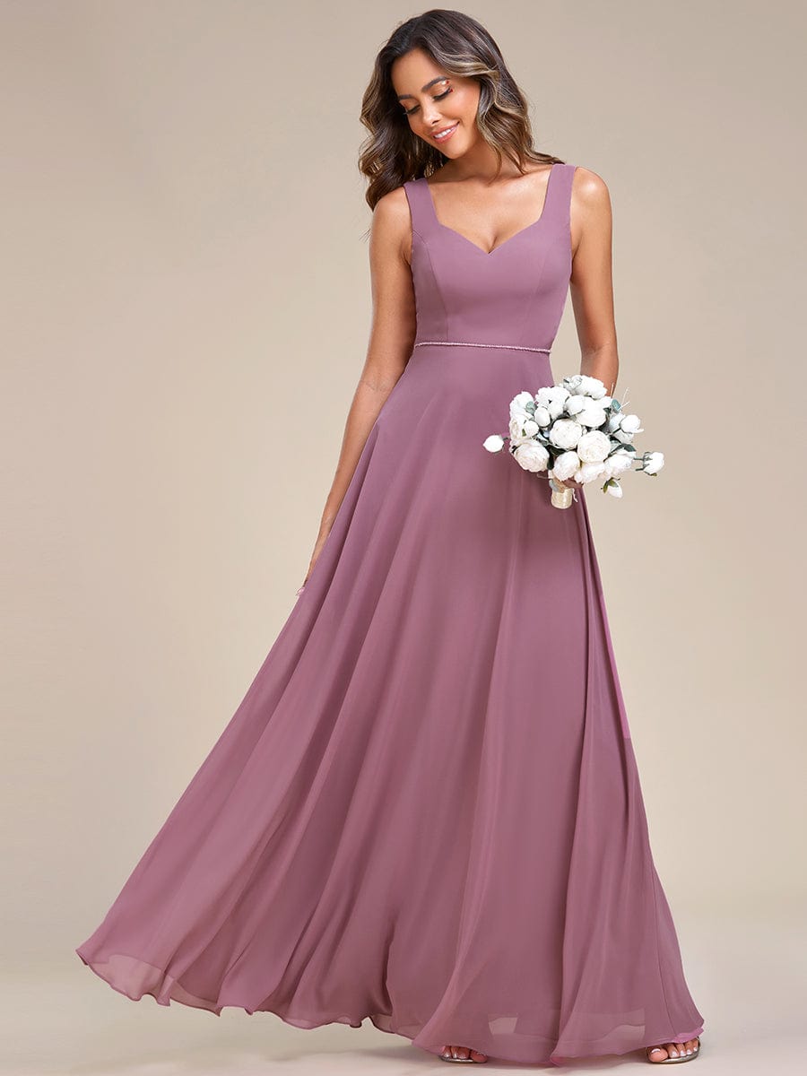 Model in an olive green chiffon sweetheart sleeveless bridesmaid dress.