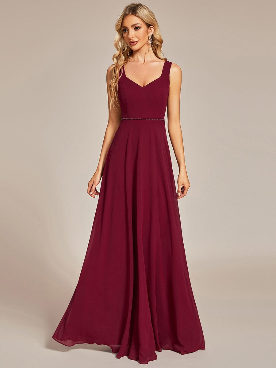 Model in a burgundy chiffon sweetheart sleeveless bridesmaid dress.