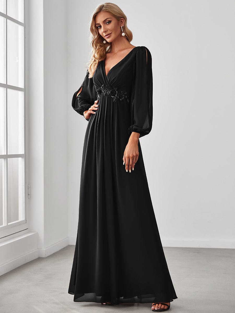Model posing in a black Weitese V-neck chiffon formal dress.