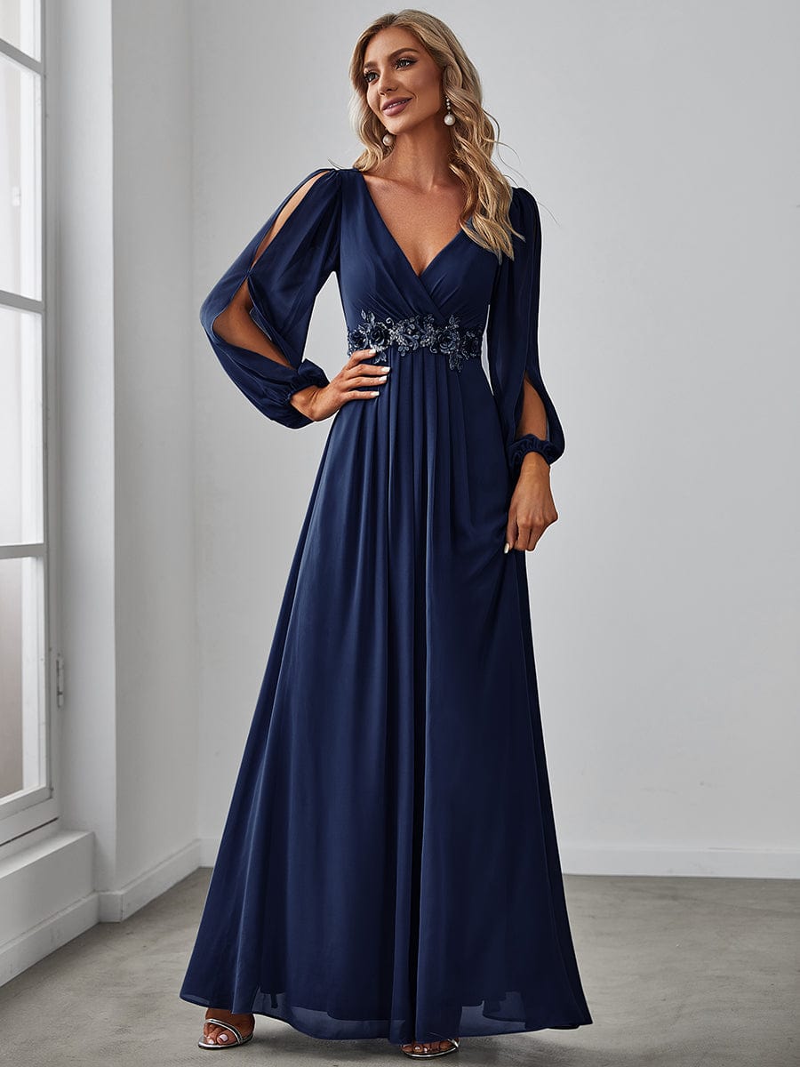 Model wearing a navy blue Weitese chiffon V-neck long sleeve formal evening gown.