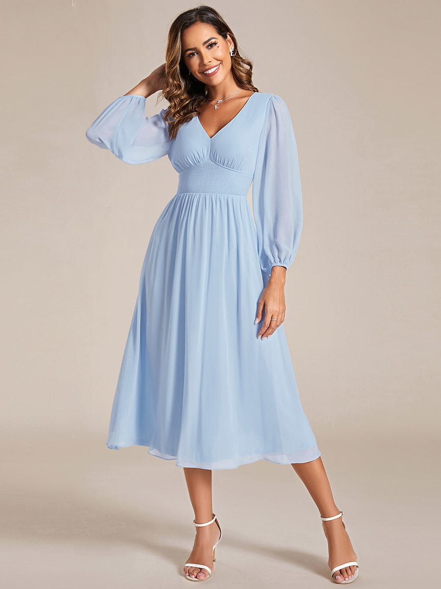 Side view of Weitese indigo blue chiffon V-neck long sleeve midi dress.