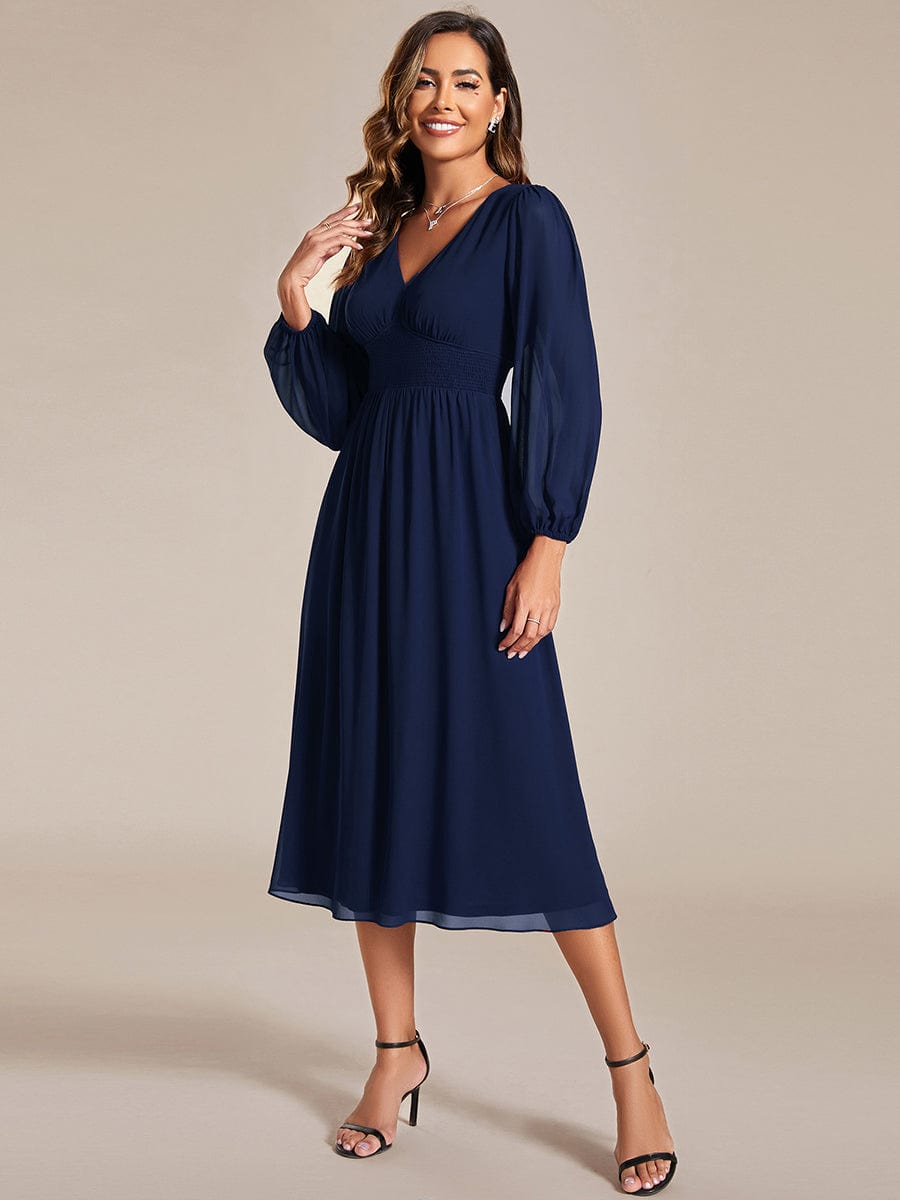 Model wearing Weitese navy blue chiffon V-neck long sleeve midi dress.