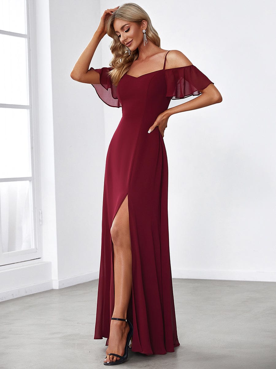 Side view of a blue cold shoulder flare sleeve dress.
