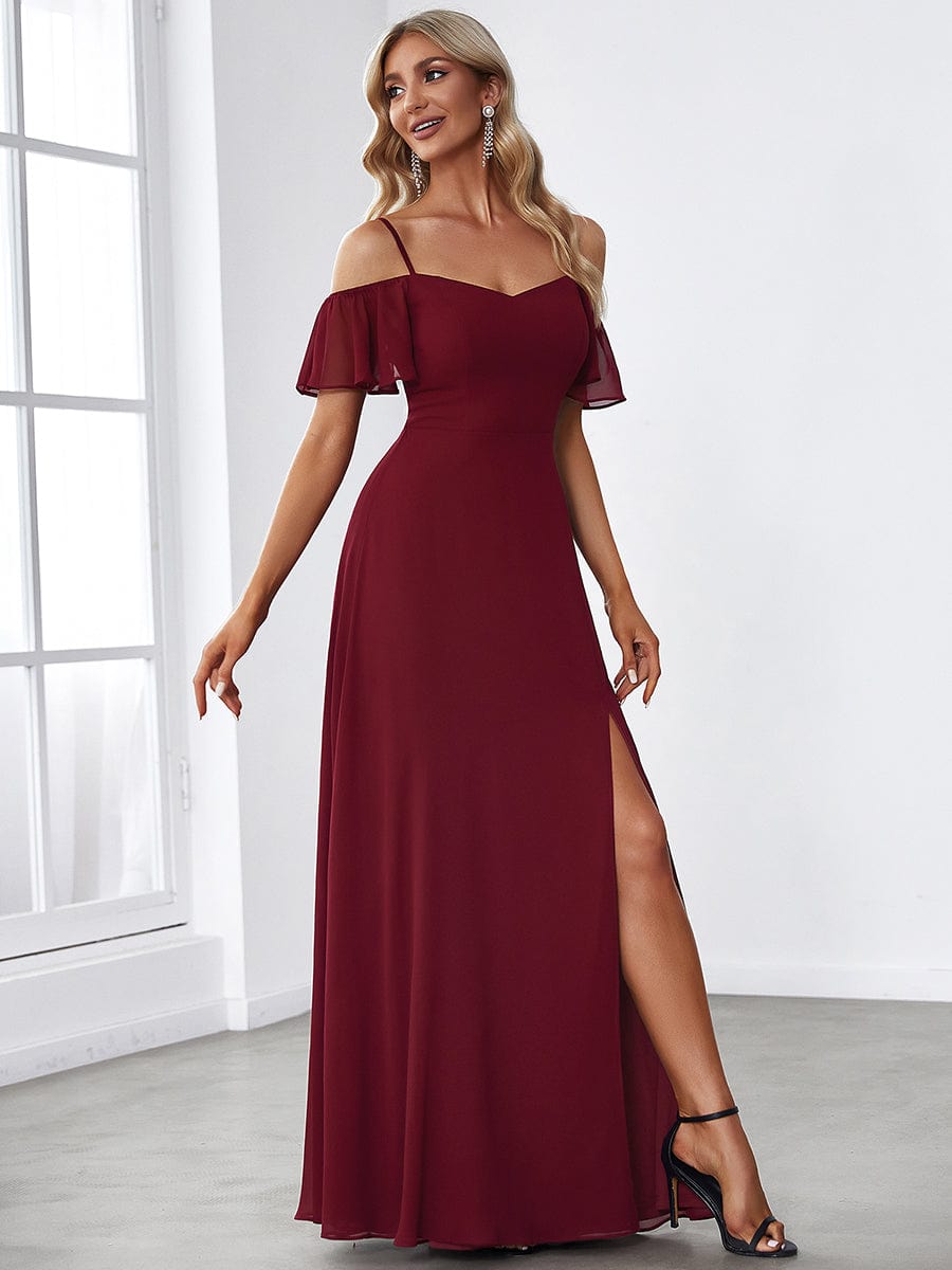 Close-up of flare sleeves on a blue cold shoulder dress.