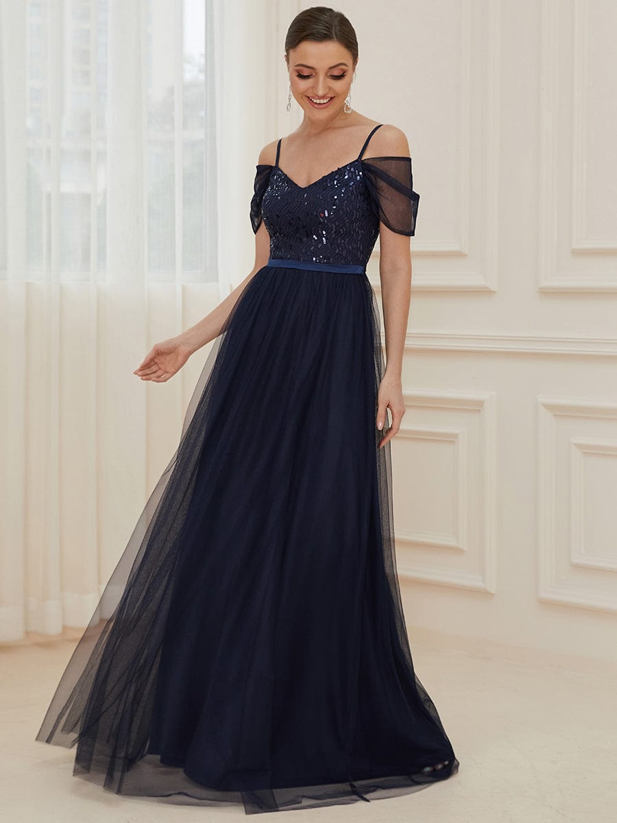 Side view of the navy blue cold shoulder sequin bodice long tulle bridesmaid dress.