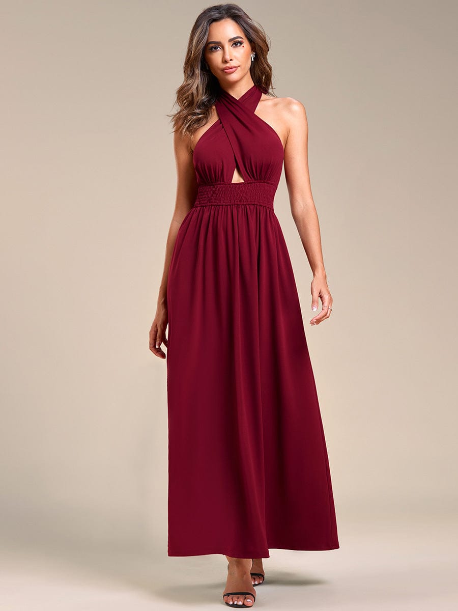 Woman wearing a red convertible halter A-line tea-length bridesmaid dress, showcasing the backless design.