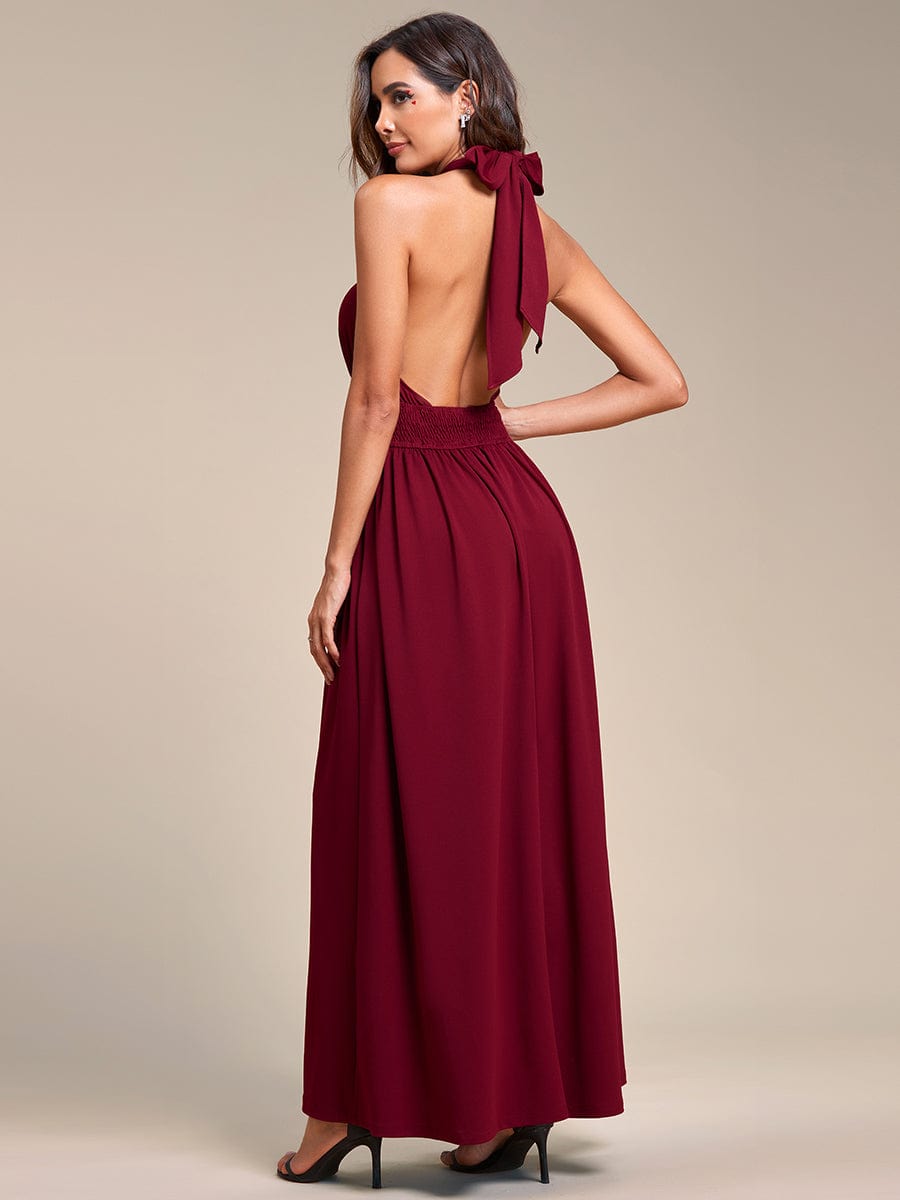 Side view of a woman in a red convertible halter A-line tea-length bridesmaid dress, highlighting the flowy skirt.