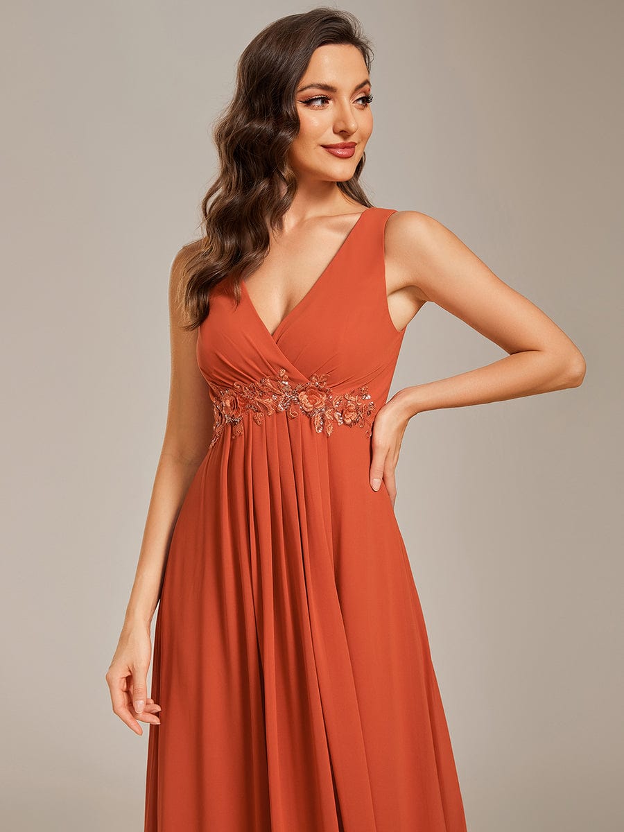 Side view of blue sleeveless chiffon formal gown.