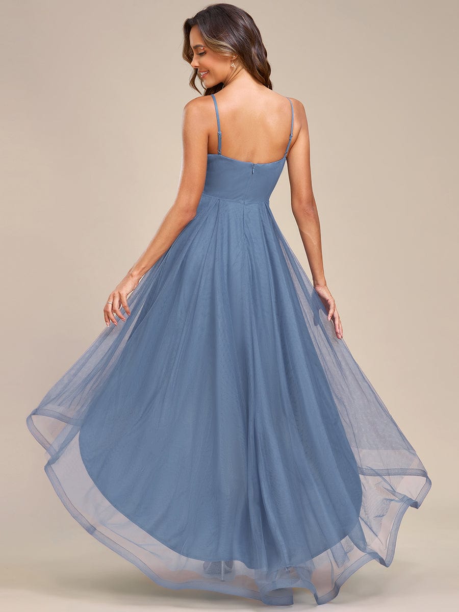 Back view of red floral embroidered high-low prom dress.