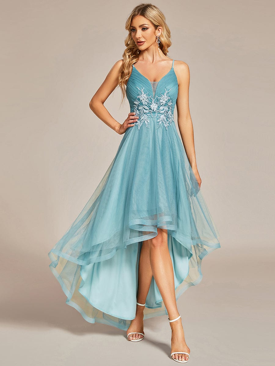 Dark blue floral embroidered high-low prom dress on a model.
