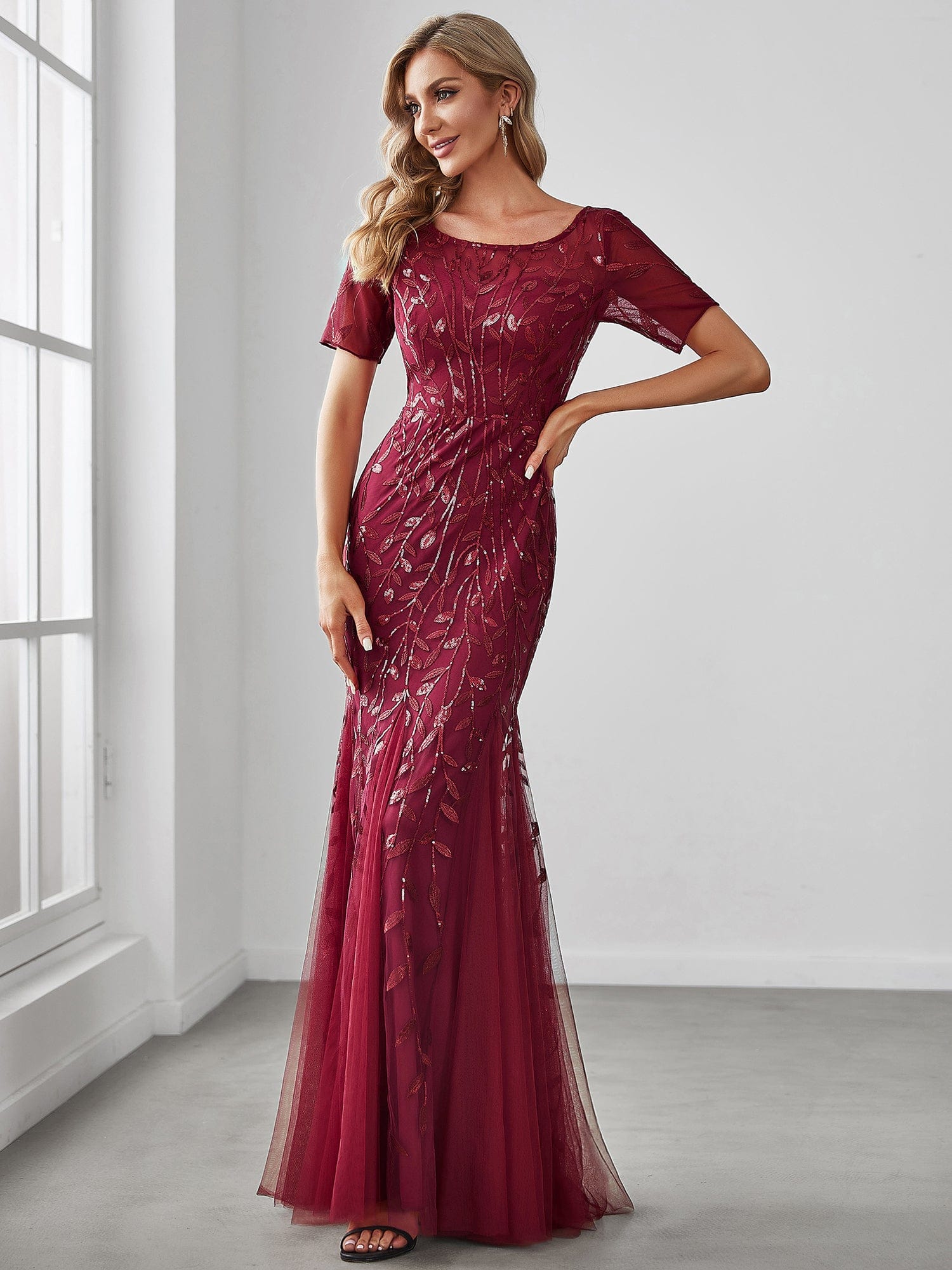 Full view of the Weitese floral sequin maxi fishtail gown with half sleeves.