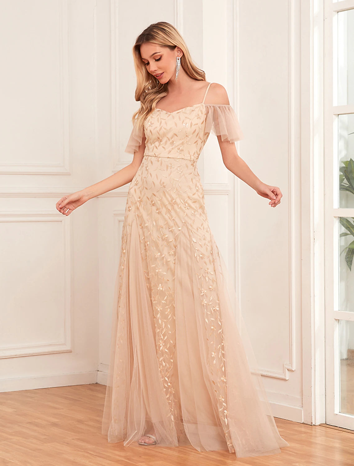 Woman wearing a gold floral V-neck short-sleeve maxi dress.