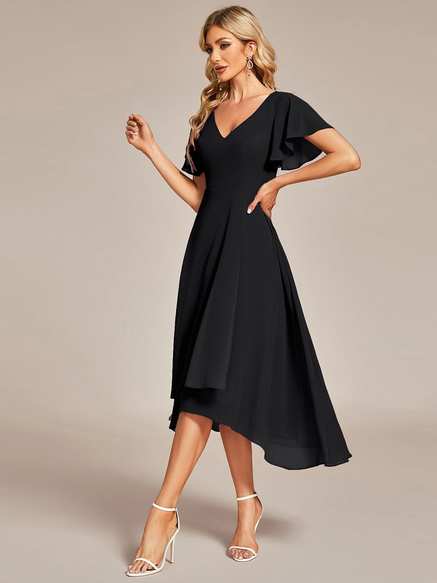 Close-up of the V-neckline and delicate ruffle sleeves on a black chiffon dress.