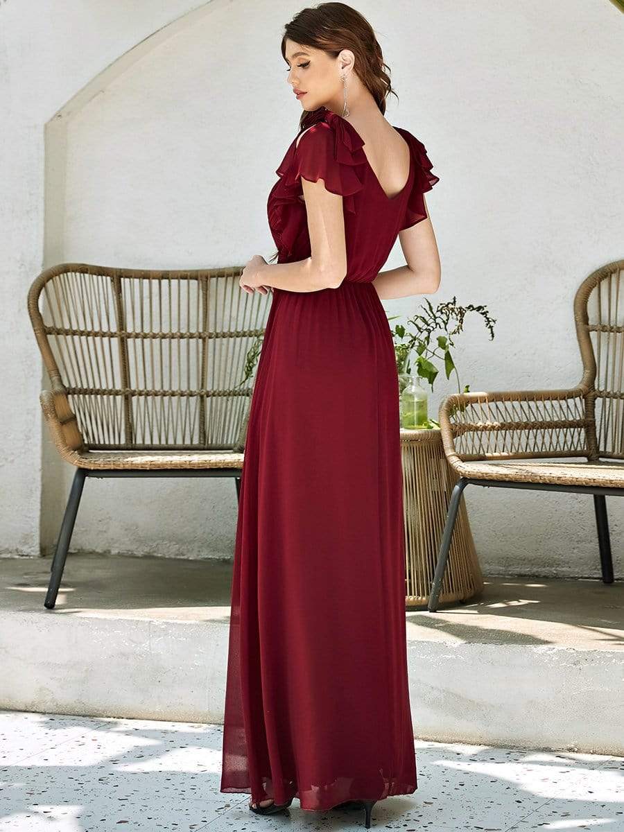 Side view of a model in a red Weitese pleated chiffon ruffle sleeve evening dress.