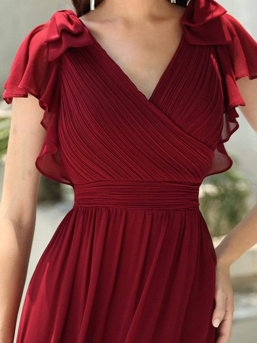 Close-up of the pleated bodice and ruffle sleeves on a red chiffon evening dress.