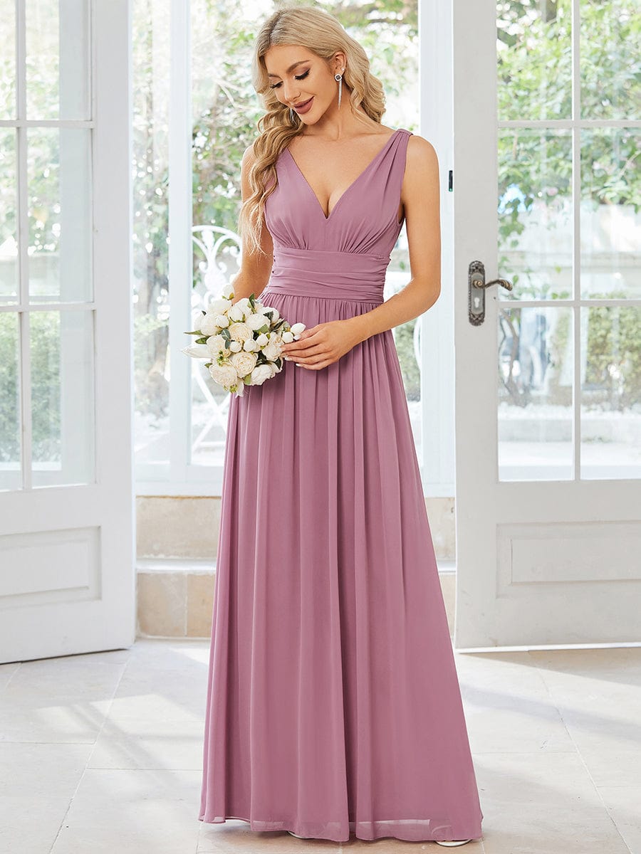 Model wearing a flowy V-neck chiffon maxi bridesmaid dress.