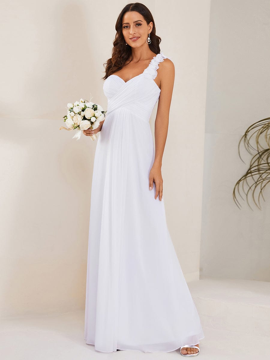 Woman in a classic white one-shoulder maxi chiffon dress.