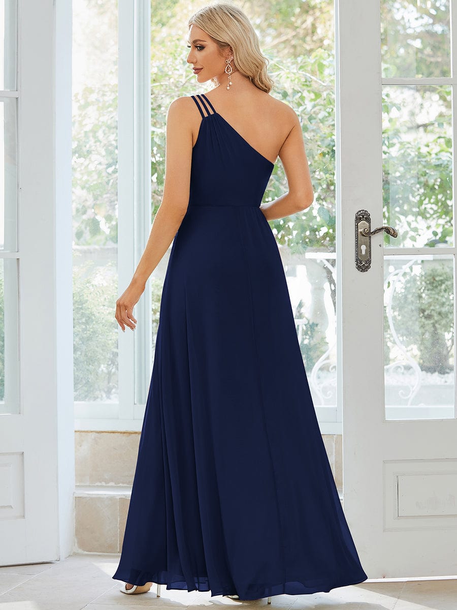 Close-up of the one-shoulder neckline and three straps on a navy blue chiffon dress.