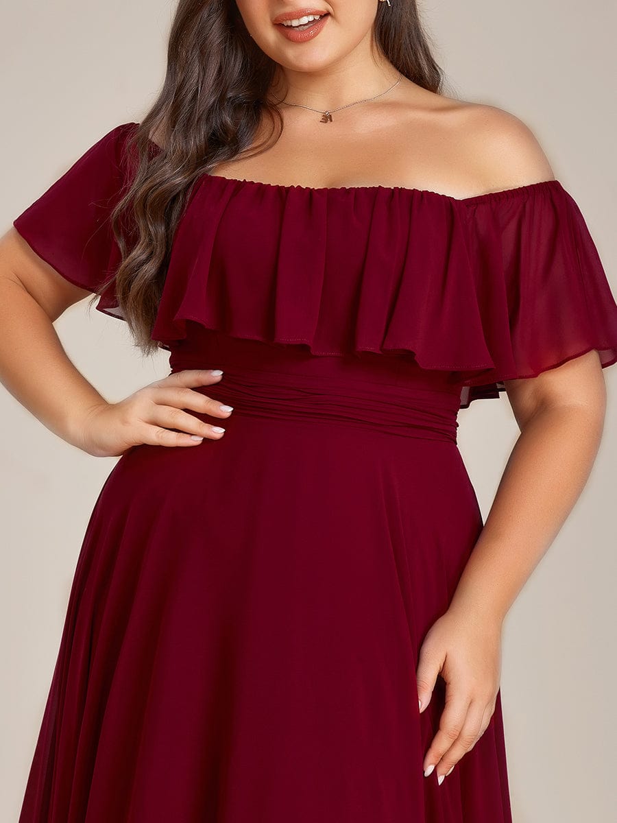 Plus size model wearing a purple off-shoulder high-low chiffon bridesmaid dress.