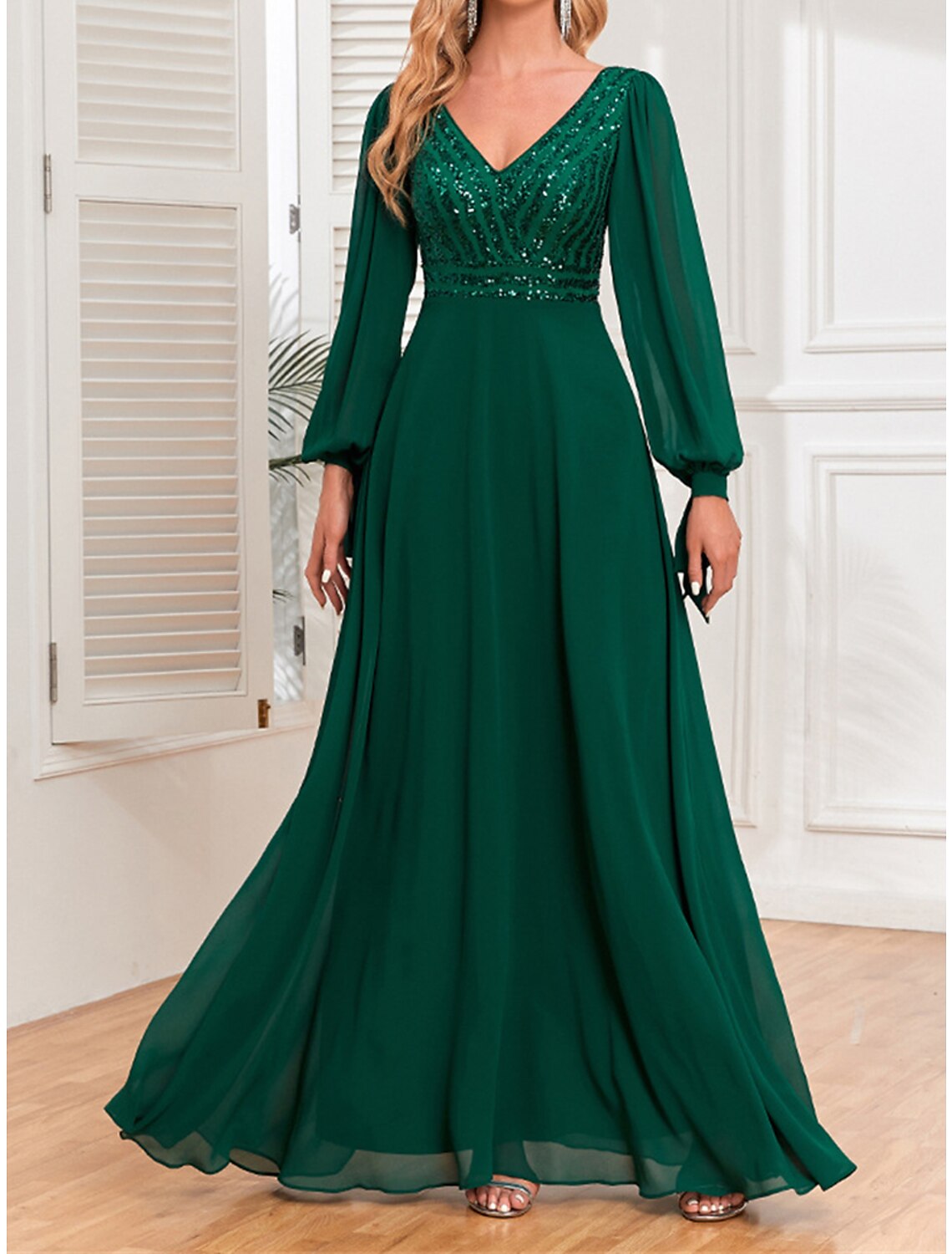 Back view of a woman in an elegant green sequin maxi dress.