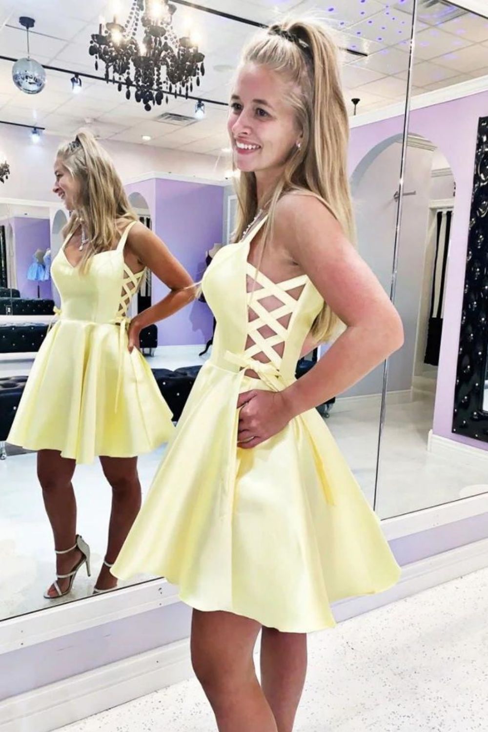 Close-up of a Weitese yellow satin mini dress, highlighting the fabric and halter neckline.