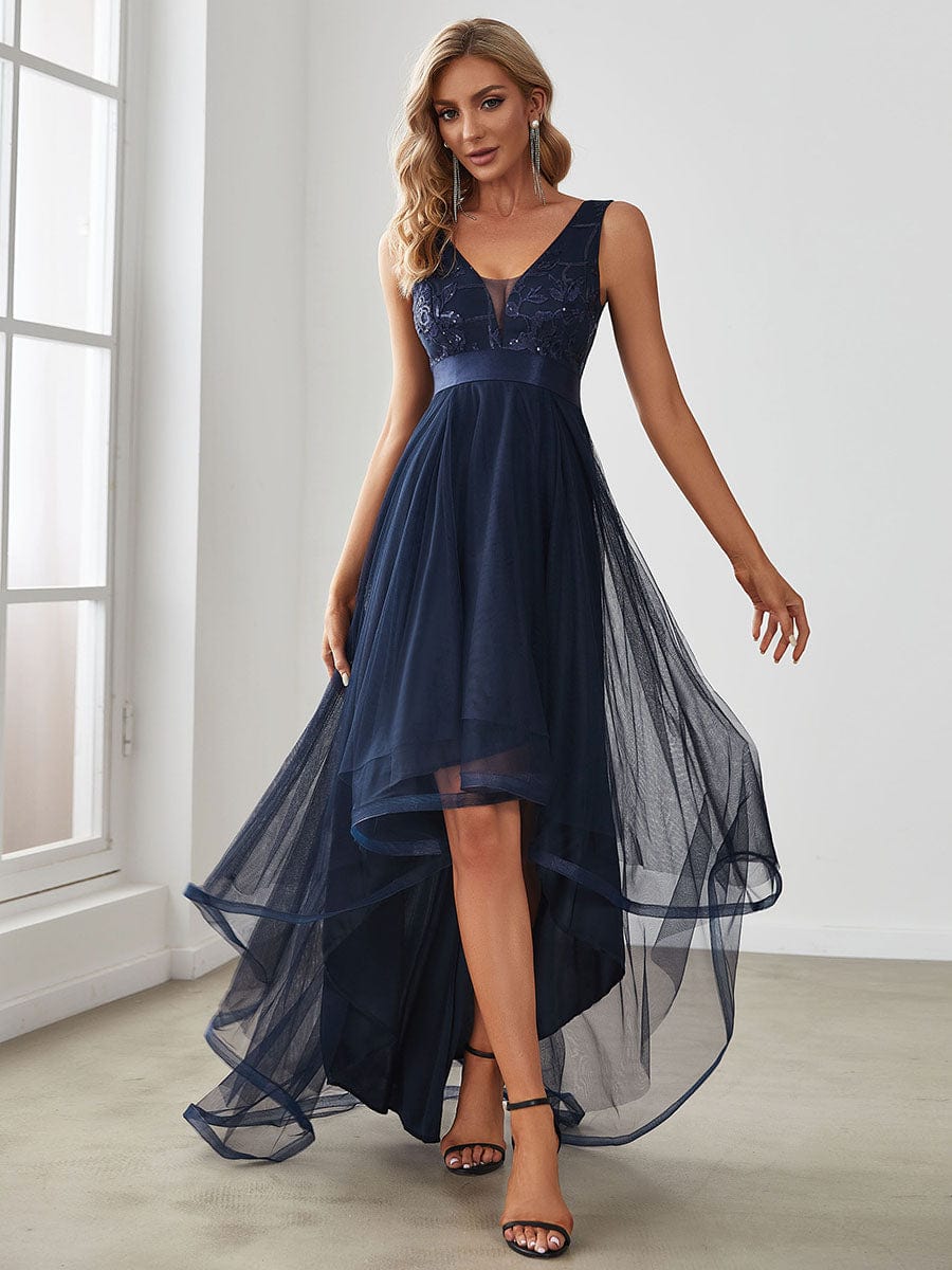 Navy blue high-low tulle prom dress with sequin details.