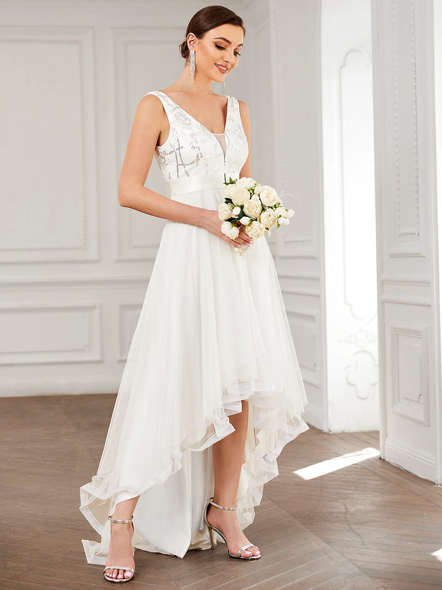 Coral high-low tulle prom dress with deep V-neck.