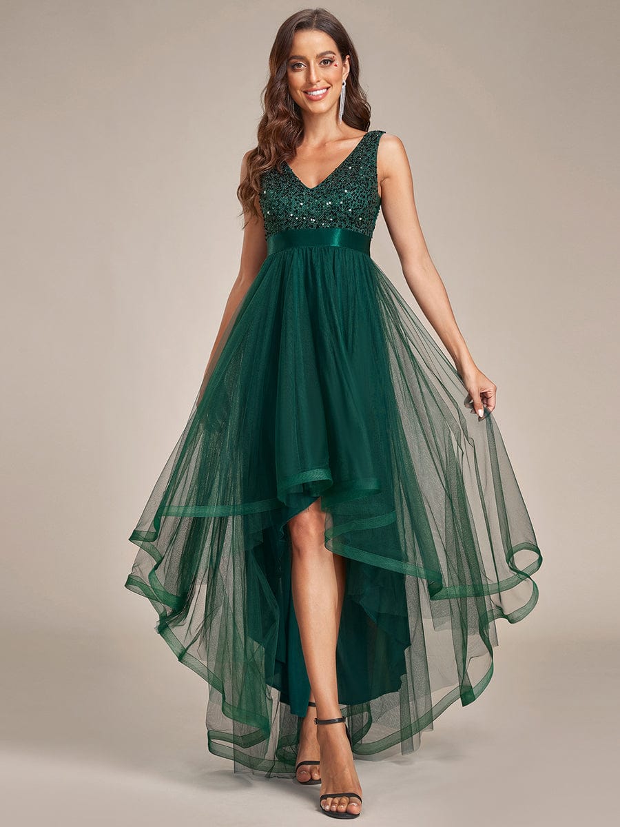 Woman in a dark green sequin bodice tulle high-low bridesmaid dress.