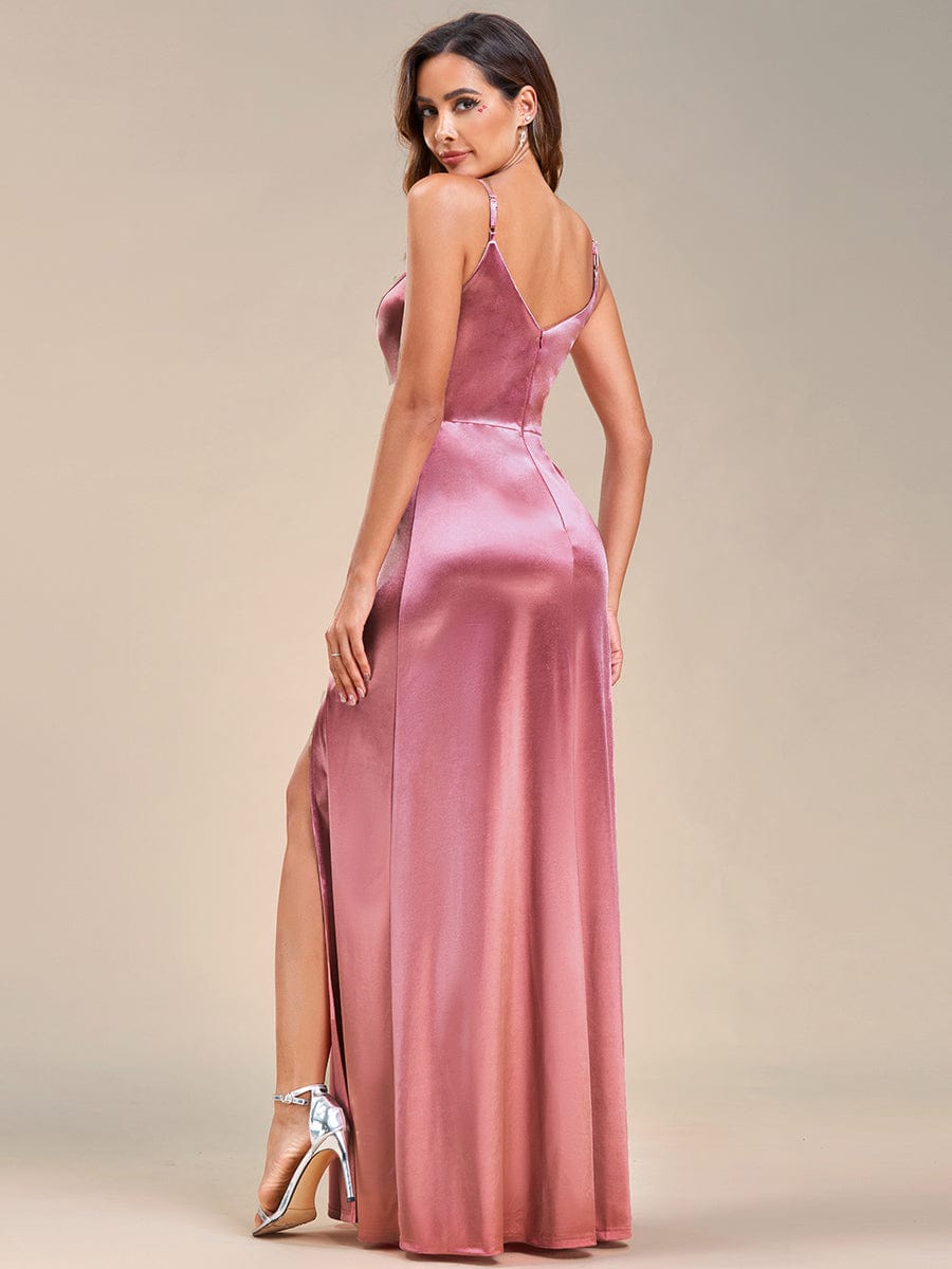 Close-up of the fabric and V-neck detail of an olive green Weitese satin evening gown.