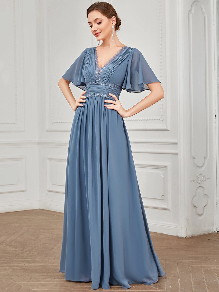 Close-up of the lace bodice and short sleeves on a navy blue bridesmaid dress.