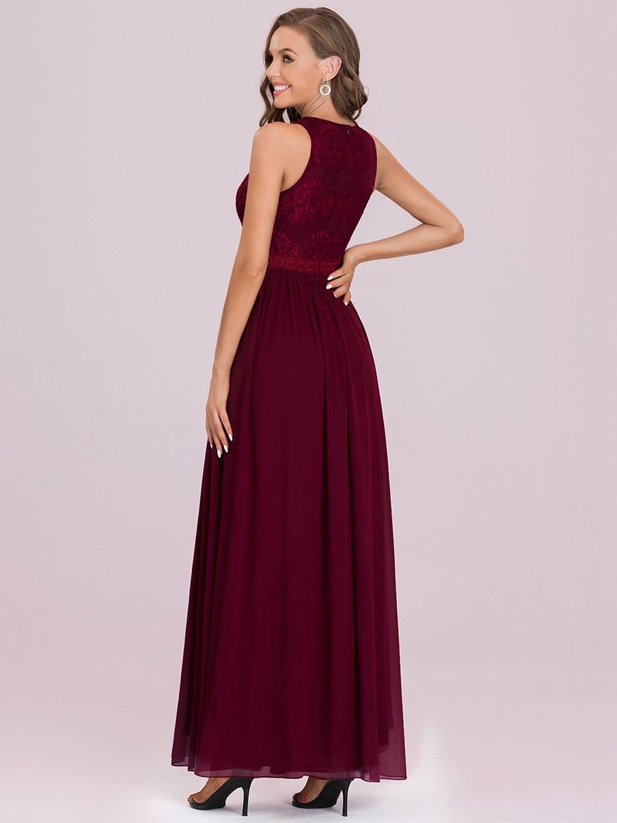 Close-up of the delicate lace bodice and empire waist of the dark blue bridesmaid dress.