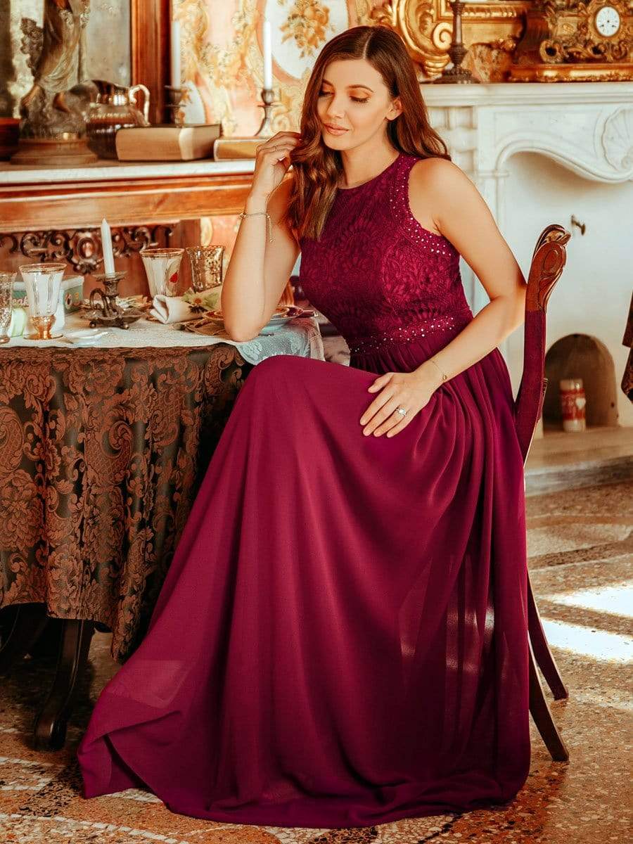 Back view of the elegant dark blue A-line bridesmaid dress with lace detailing.