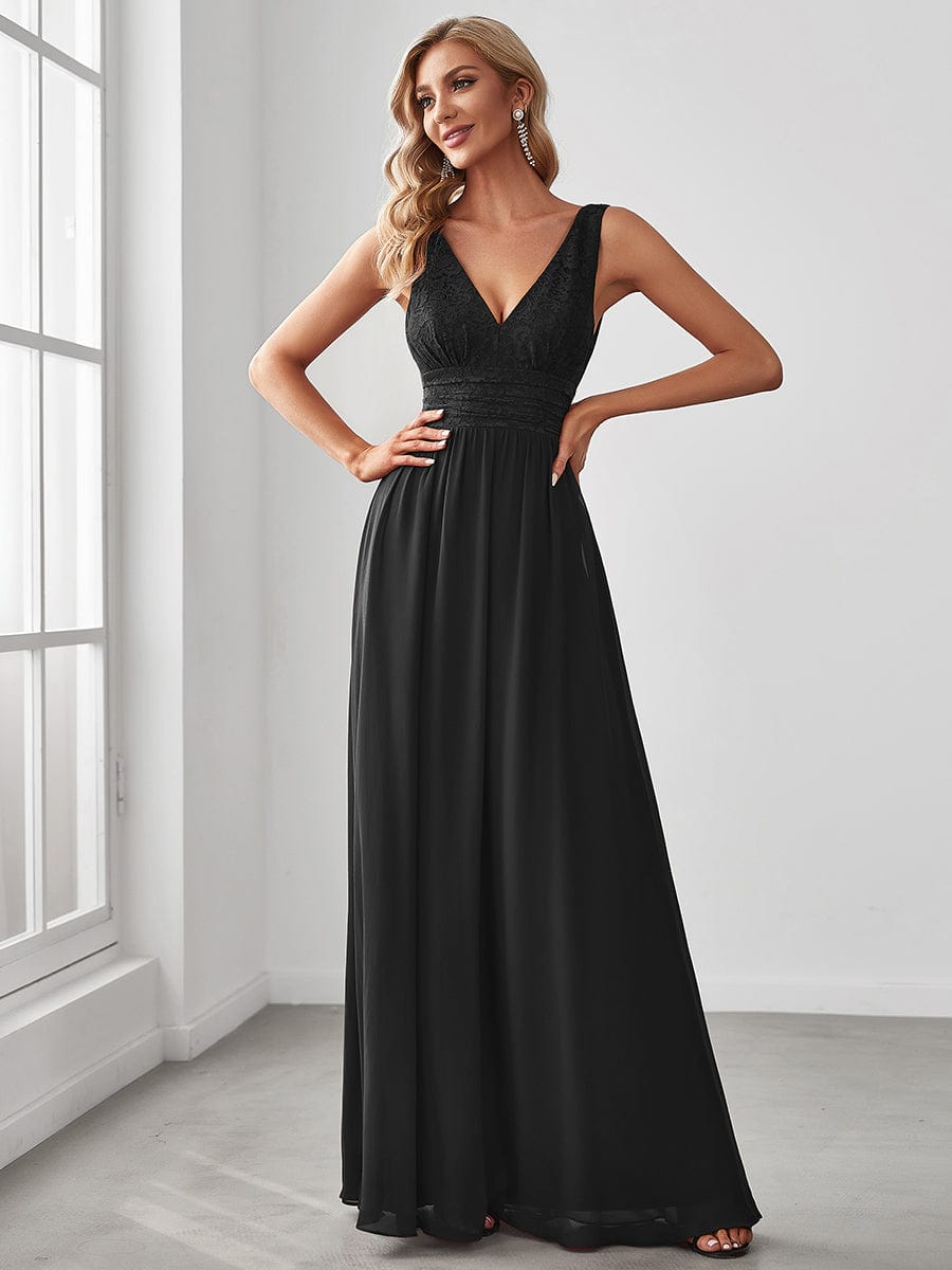 Model wearing a black lace and chiffon empire waist V-back evening gown.