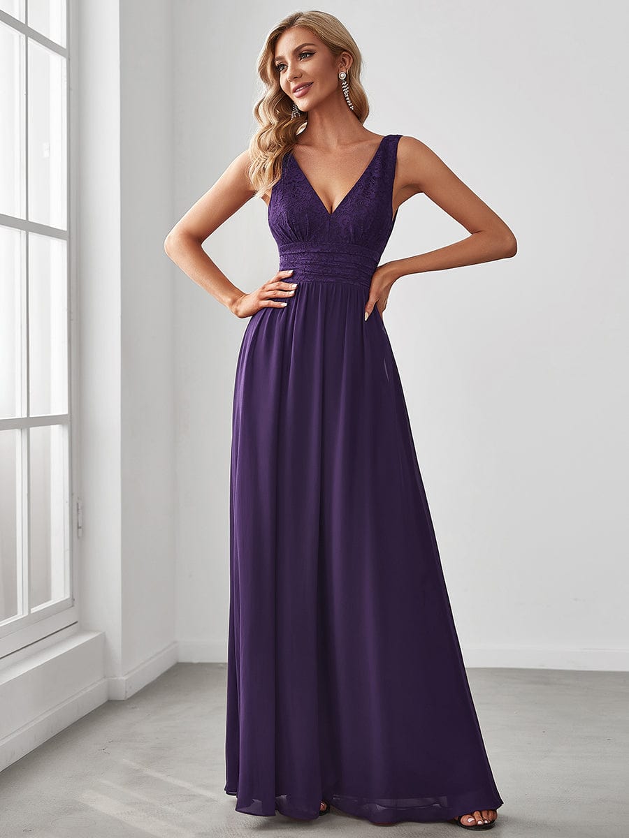 Model wearing a dusty blue lace and chiffon empire waist V-back evening gown.