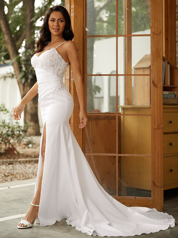 Side profile of the bride in the sleeveless sheath column wedding dress.
