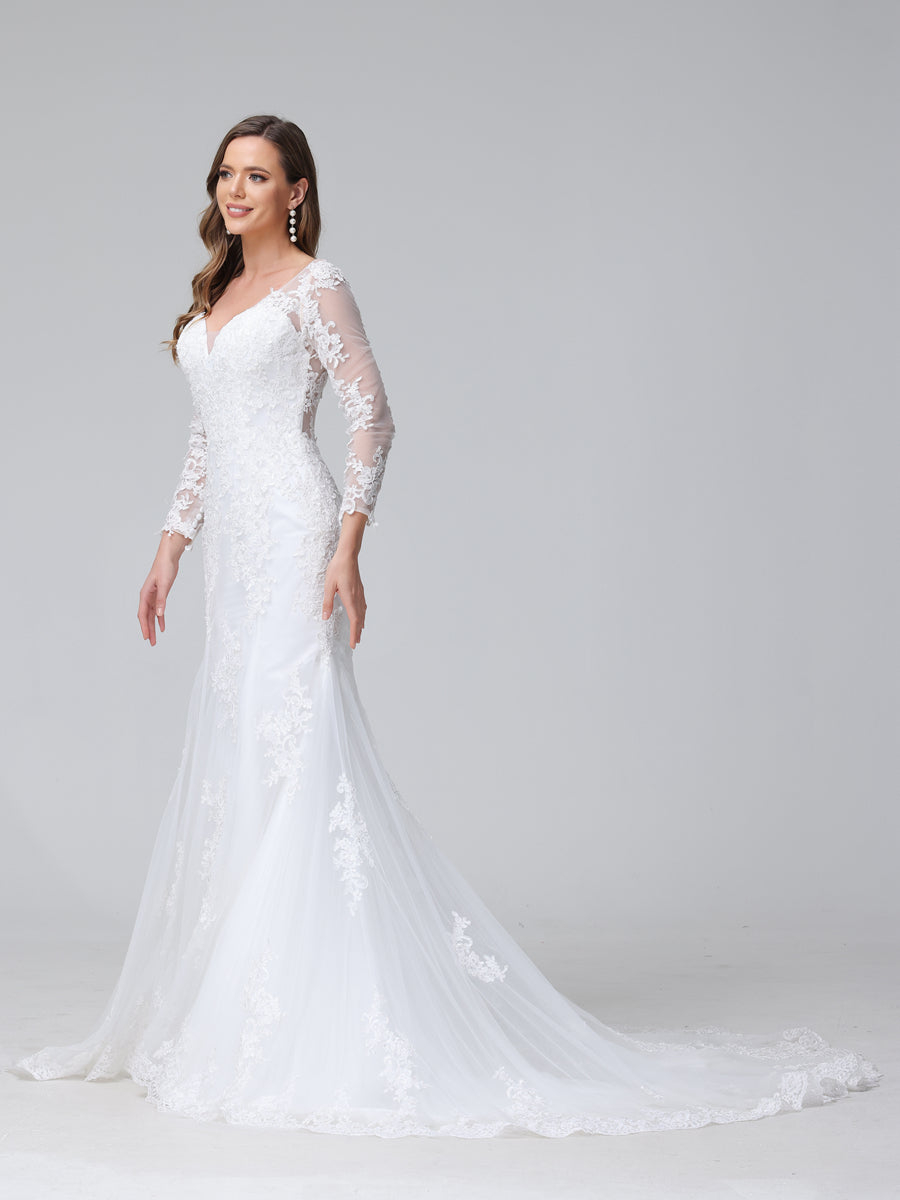 Full length view of the bridal gown with a flowing trumpet skirt.