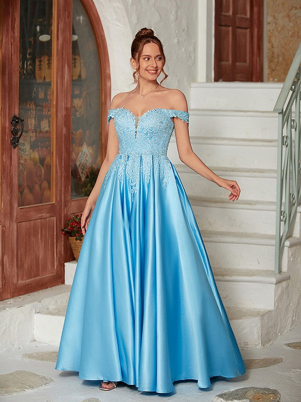 Close-up of off-shoulder lace and satin bodice on a light blue dress.
