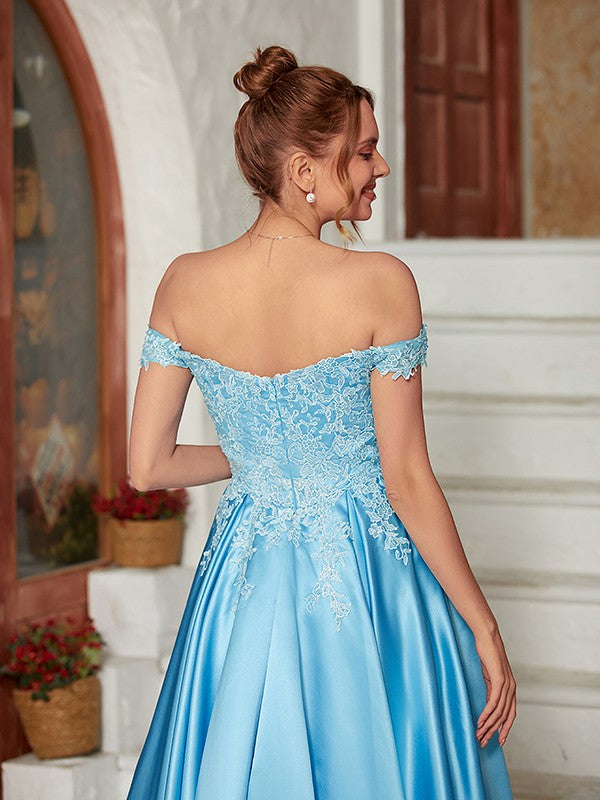 Detail of delicate lace and smooth satin fabric on a blue dress.