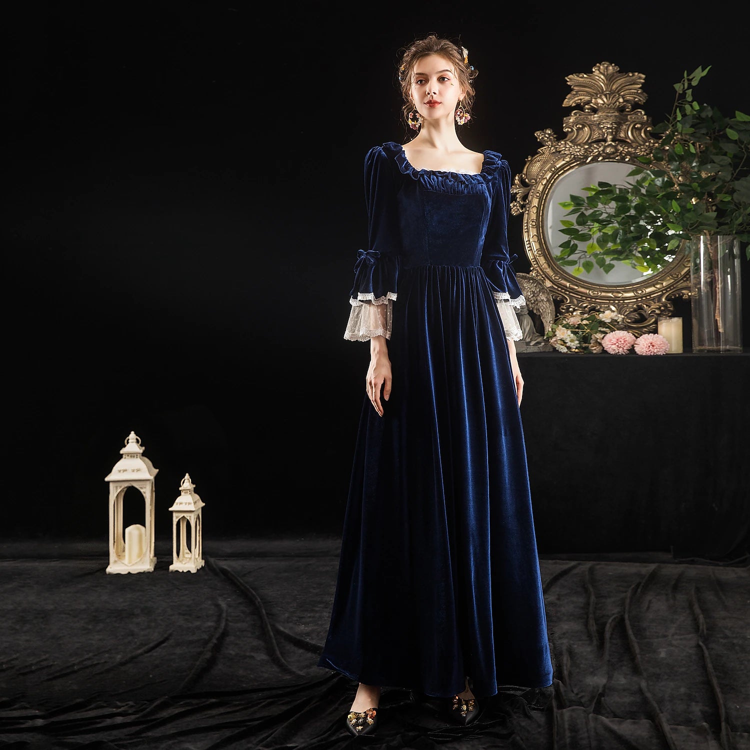 Model wearing a dark Rococo Baroque off-shoulder ball gown with intricate details.