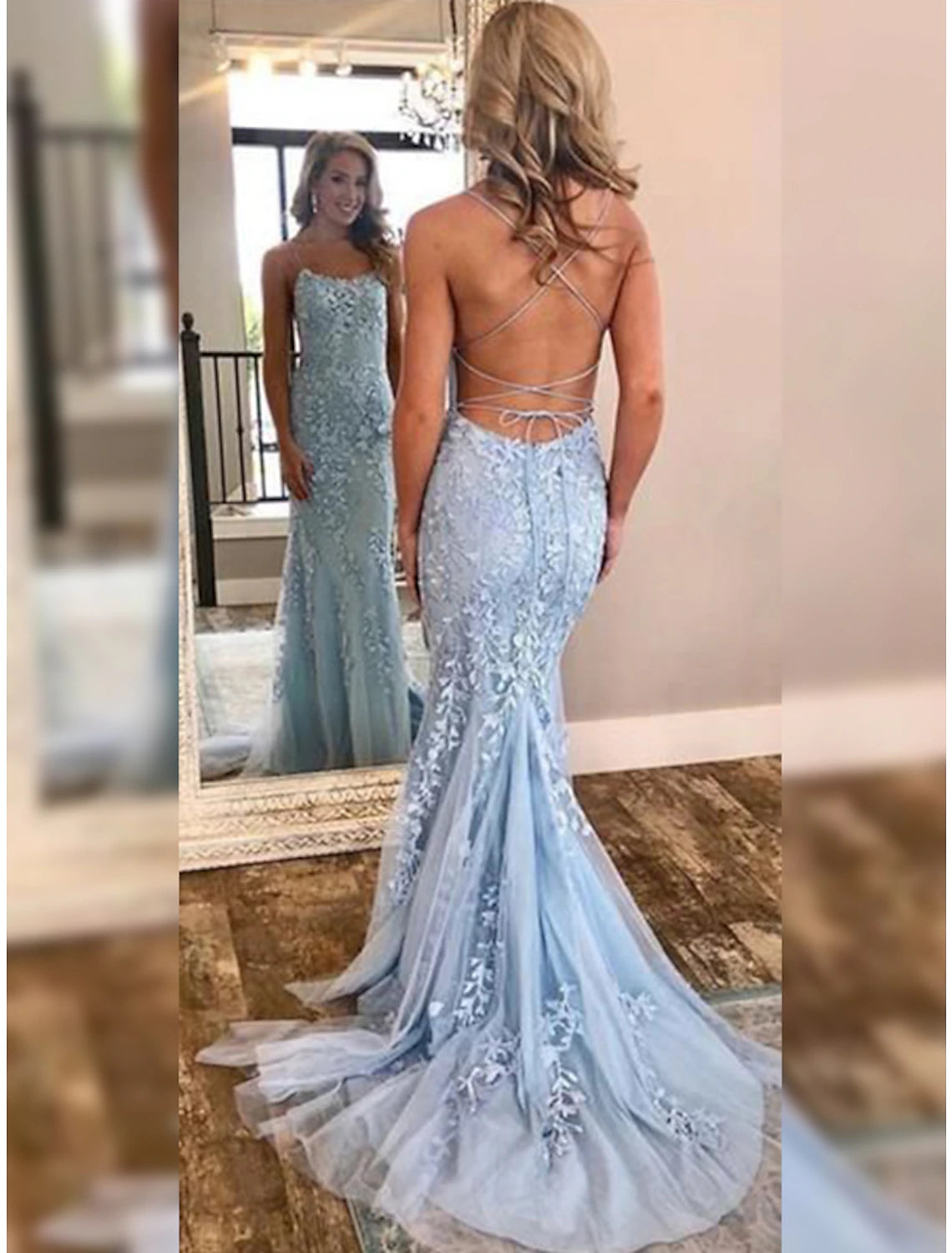 Elegant light blue mermaid prom dress with halter neck, open back, and intricate appliques.