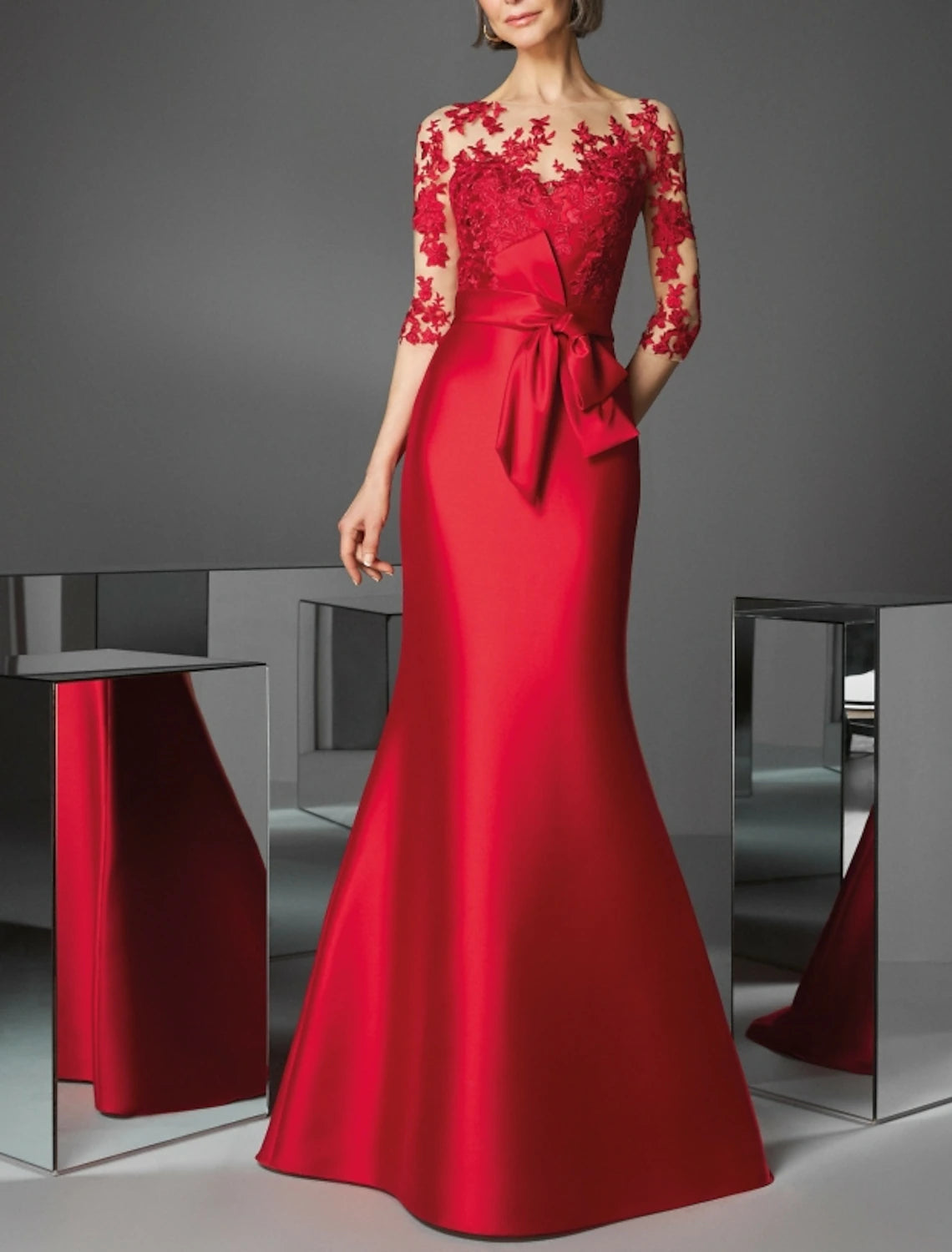 Elegant red mermaid evening gown with illusion neckline and 3/4 sleeves.