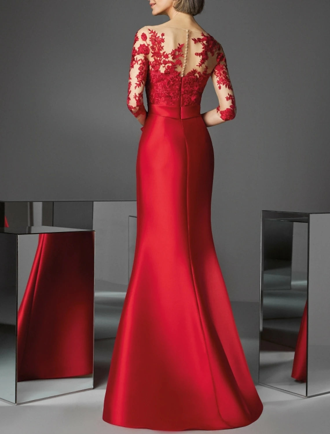 Back view of the red mermaid evening gown with delicate appliques.