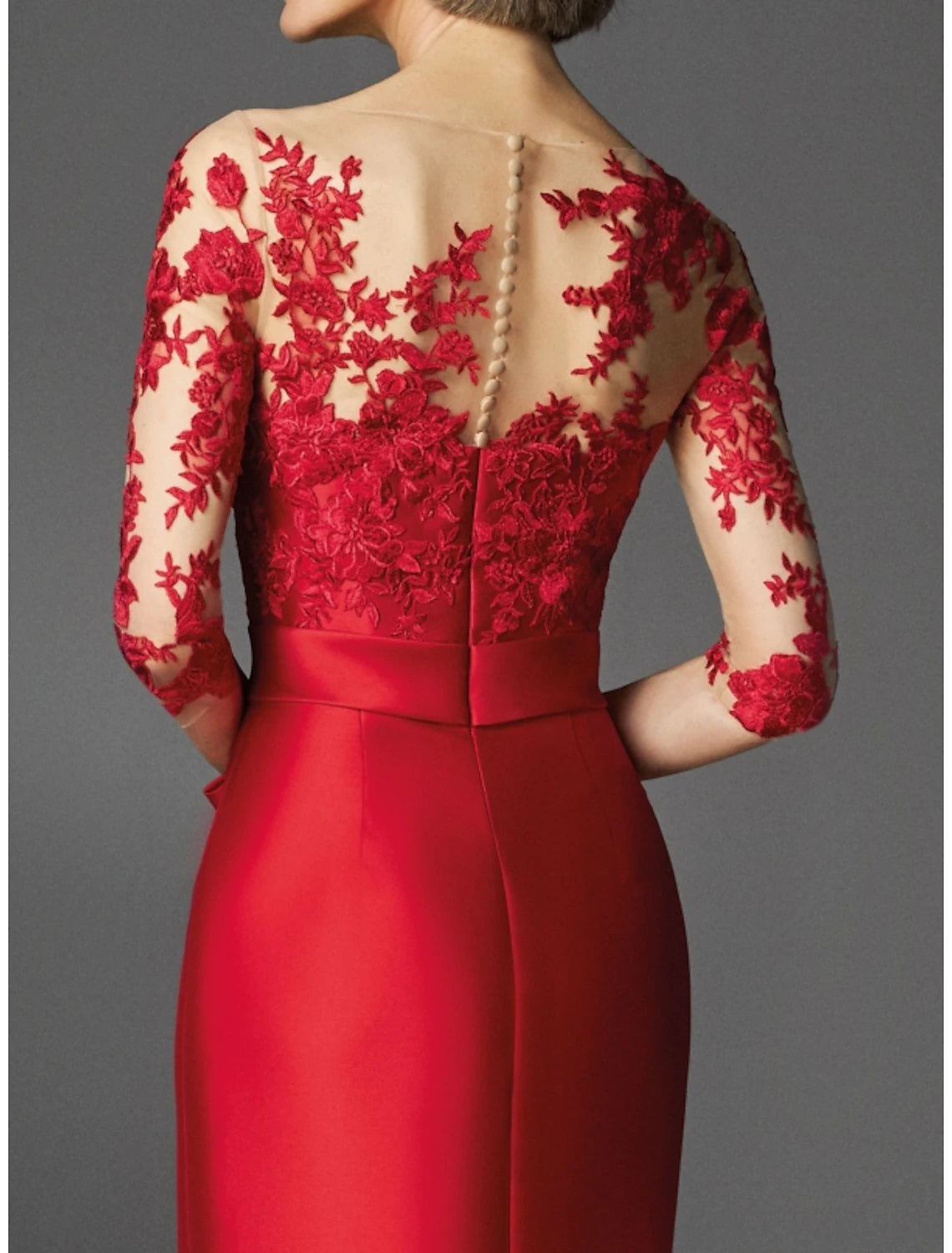 Close-up of the illusion neckline and applique details on the red gown.