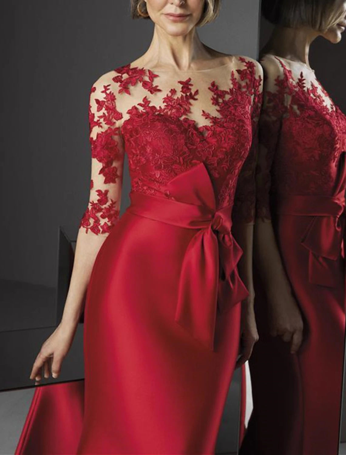 Side profile of the red mermaid evening gown showcasing its silhouette.