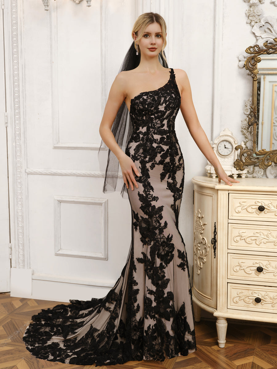 Woman in a white one-shoulder mermaid wedding dress with appliques.